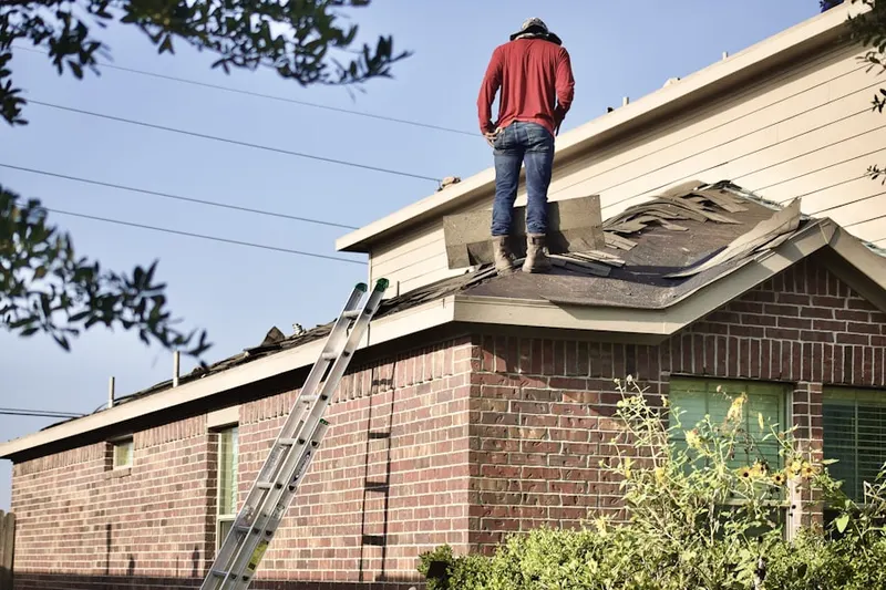 Professional roofer working on a residential roof in Braddock Hills Estates
